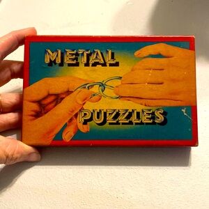 1930s Colmor No 106 metal puzzle box and five puzzles made in usa